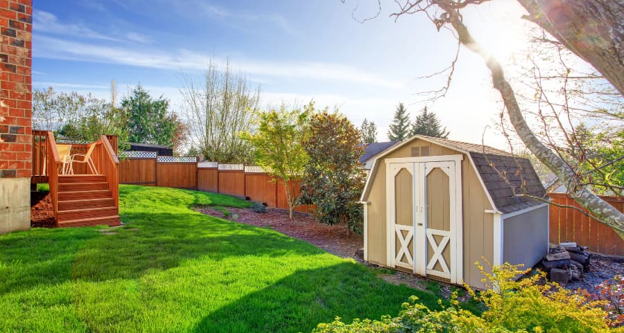 Fenced backyard with storage shed in Saginaw